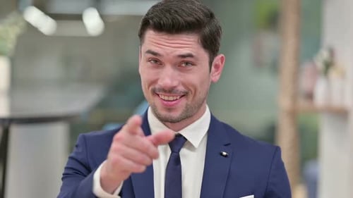 Assertive Young Businessman with Pointing and Inviting
