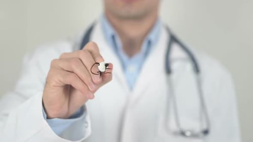 Doctor Writes 'Genetic Testing' on Clear Surface