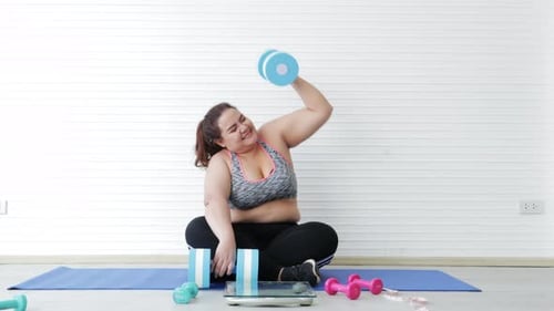 Woman Working Out with Dumbbells at Home