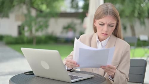 Worried Woman Working on Laptop Outdoors