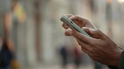Close Up of Male Hands Tapping and Scrolling on Mobile