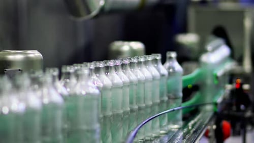 Glass Bottles on Conveyor Belt in Factory
