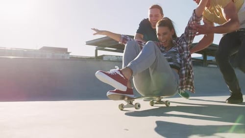 Friends Having Fun with a Skateboard at Skatepark