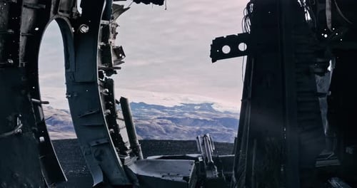 Plane Wreckage In Black Sand And Mountains