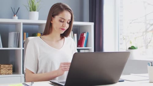 Young Woman Works at Home Office Using Computer.