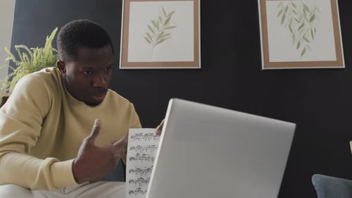 Adult Man Studying Music with Laptop at Home