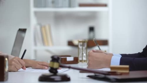 Attorney and Client Sign Legal Agreement in Office