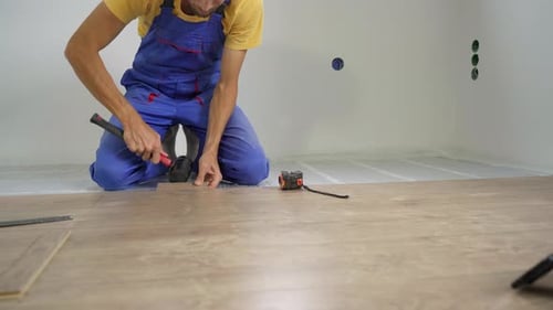 A Man Professional Laminate Installer Laying Laminate Wood