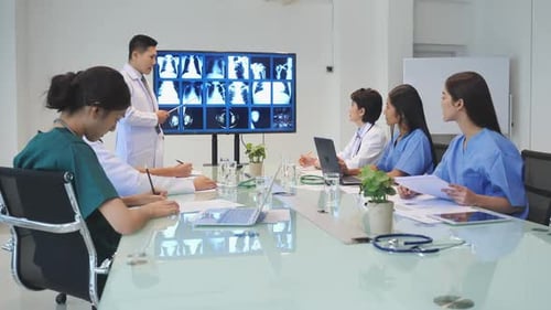 Medical Team Discussing X-Rays in Conference Room