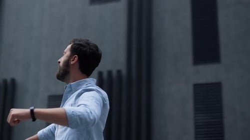 Happy Bearded Man Celebrating Victory in Downtown Area