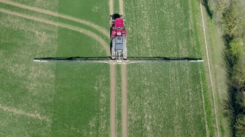 Tractor Sprays Fertilizer on Field from Above
