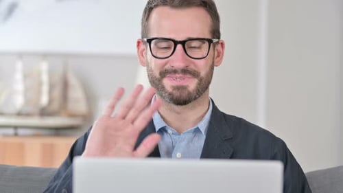 Close Up of Young Businessman Doing Video Call on Laptop