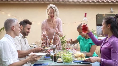 Adults Enjoying Outdoor Meal Together