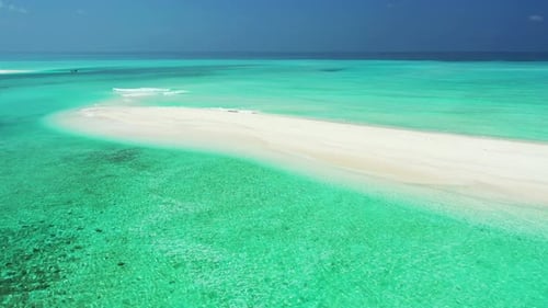 Tropical flying tourism shot of a sunshine white sandy paradise beach and blue ocean background in c