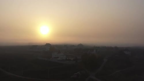 The Bright Sun Shines Over a Small Town on an Autumn Morning. Morning Foggy Sky. Lightly Drizzle