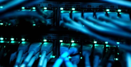 Network Switch With Cables and Turquoise Lights