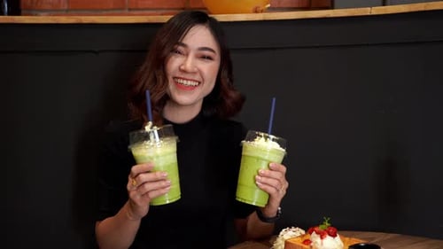woman drinking green Tea frappe in cafe