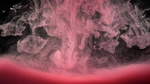Pink Paint Clouds Flowing on Black Background