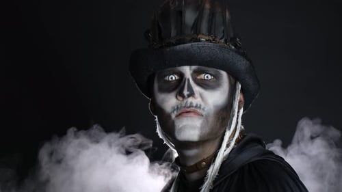 Creepy Man with Skeleton Makeup Appearing From Darkness When Light Falls on Him, Making Faces