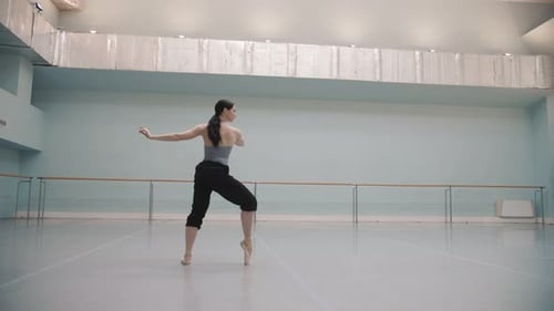 Ballet Dancer Practicing in Studio, Wide Shot