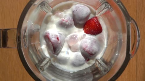 Milkshake with Strawberries and Creamy Milk Yogurt is Mixed in a Blender