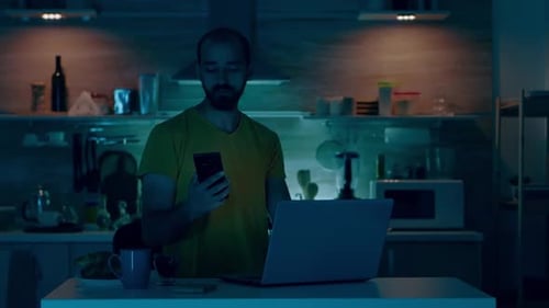 Man Working on Laptop in Bright Kitchen