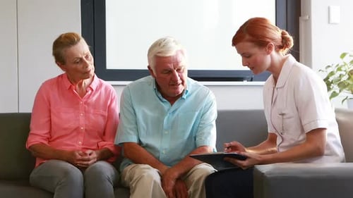 Senior Couple Consults with Health Professional in Modern Office