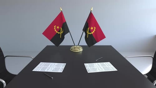 Angola Flags on Conference Table for International Negotiations