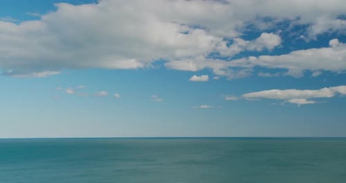 Sea View on the Nice Summer Day, Clean Blue Water and Smooth Waves, Blue Sky with Clouds, Horizon