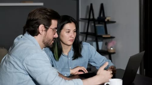 A young Man Discusses an online Project With a Colleague, Two Managers Work at Home, Use A laptop