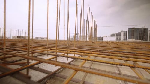 Iron reinforcement is basis for pouring foundation of house with concrete slab.