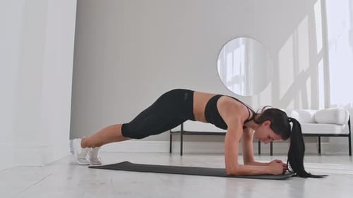 Woman Does Mountain Climber Exercise on Yoga Mat