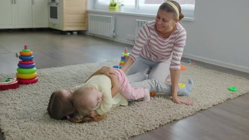 Mother and Two Daughters Playing Together at Home