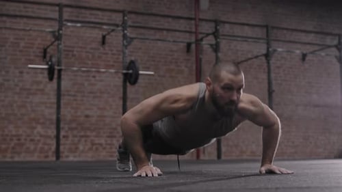 Strong Man Doing Push-Ups in Modern Gym