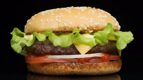Close Up of Juicy Hamburger on Dark Surface