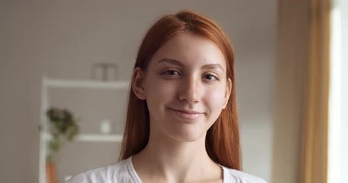 Close Up of a Smiling Young Woman Indoors