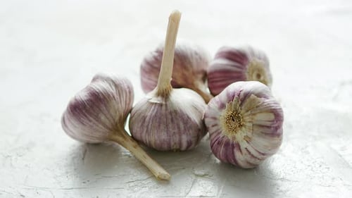 Heap of Unpeeled Garlic Bulbs