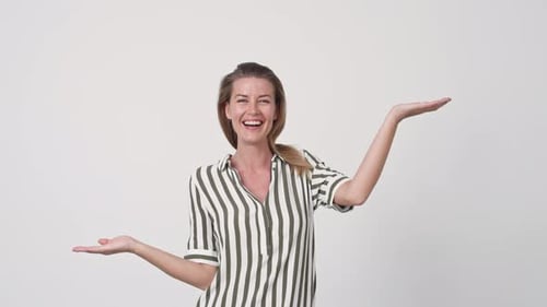 Woman Smiling and Gesturing in Studio Setting