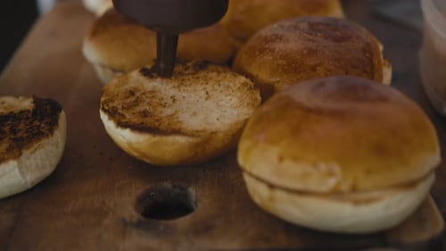 Bottom Burger Bun Being Prepared with Sauce