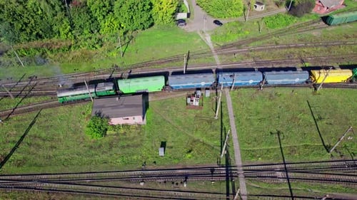 Colorful Freight Train on Rural Railroad Tracks