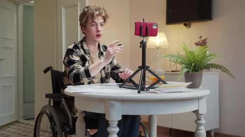 Young Adult in Wheelchair Vlogging Indoors
