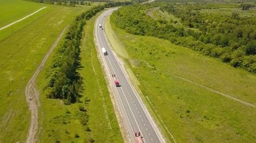 Trucks Traveling on Rural Highway Aerial View