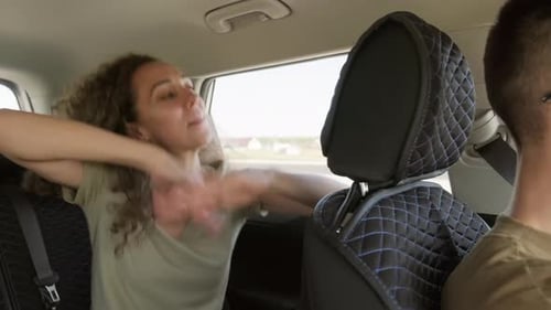 Woman Dances in Car Backseat