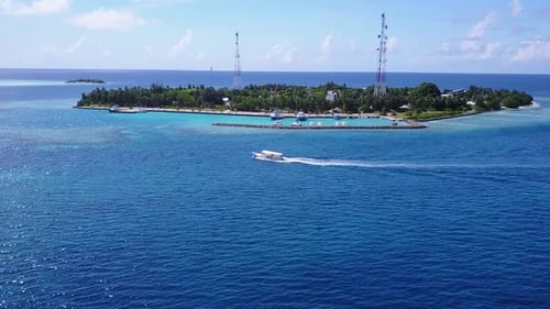 Sunny panorama of tropical shore beach journey by blue water with sand background near surf