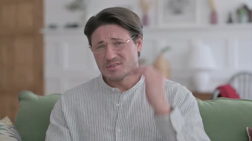 Man Rubbing Neck Due to Pain and Discomfort