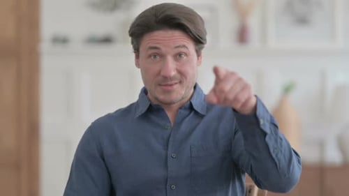 Man Points Directly to Camera