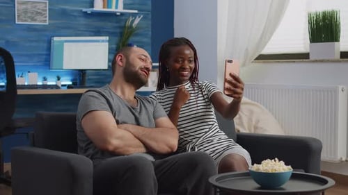 Interracial Partners Using Video Call on Smartphone
