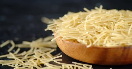 Close up of Raw Noodles in Wooden Bowl
