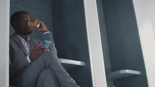 Stylish Man Drinks Coffee and Uses Smartphone
