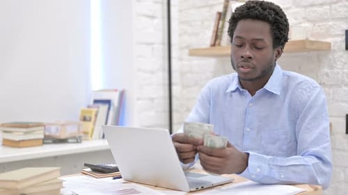 Working African Guy Counting The Money